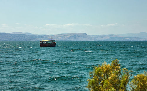 Boat sailing in sea against sky