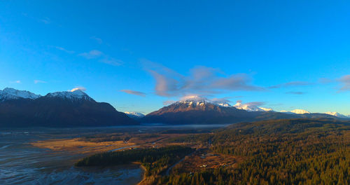 Scenic view of mountains against blue sky