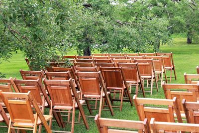 Chairs on grass against trees