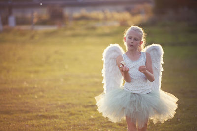 Portrait of girl wearing angel costume