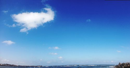 Low angle view of sea against blue sky