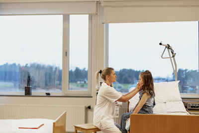 Doctor checking patients throat
