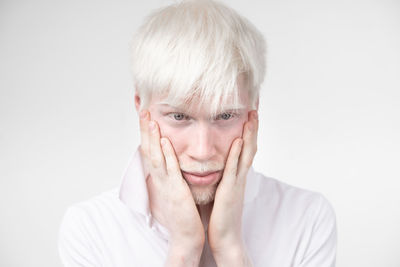 Portrait of mature man against white background