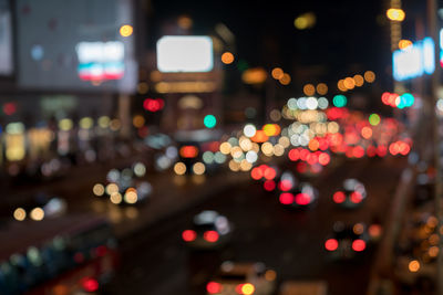 Defocused image of illuminated city street at night