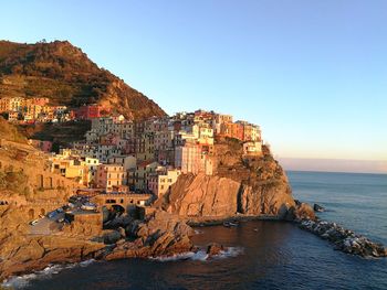 Panoramic view of sea and buildings against clear sky