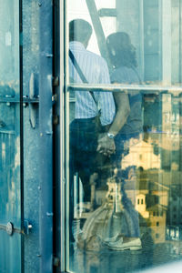 Low section of woman standing by window