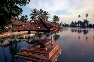 Built structure by lake against sky