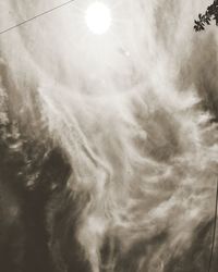 Low angle view of sun shining in sky