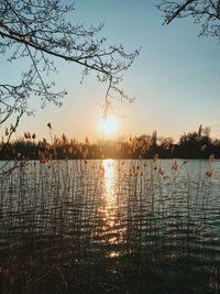 Scenic view of lake against sky during sunset