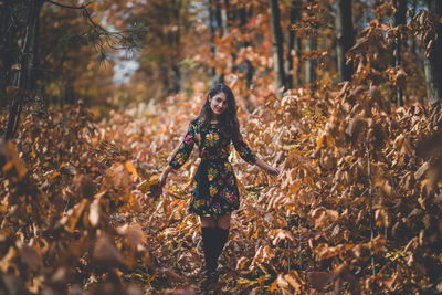 Portrait of young woman standing on land