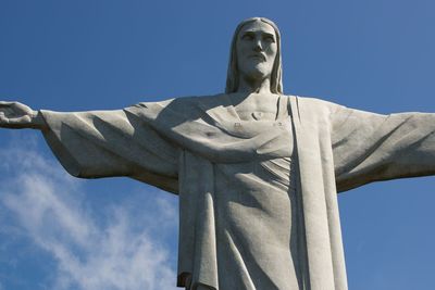 Low angle view of statue against blue sky