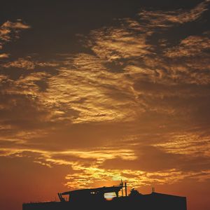 Low angle view of silhouette buildings against sky during sunset