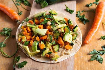 Vegan burrito with chickpeas, zucchini, carrots and avocado