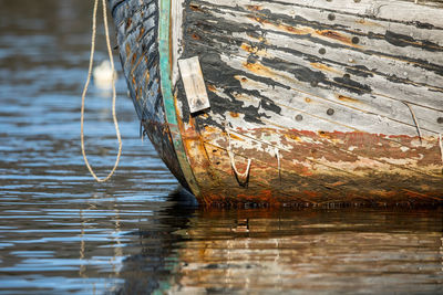 Close-up of abandoned boat in sea