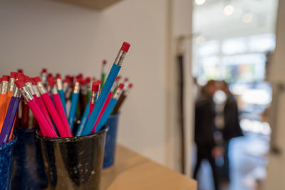 Close-up of colored pencils in containers