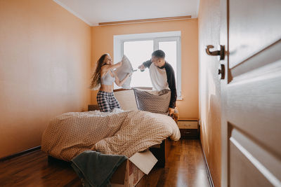 Rear view of friends standing at home