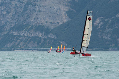 Boat in sea against mountain