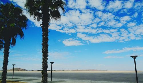 Scenic view of beach against blue sky