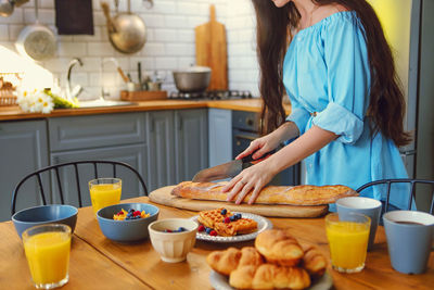 Woman having food at home