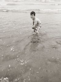 Portrait of shirtless boy enjoying in sea