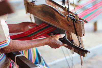 High angle midsection of man working on loom