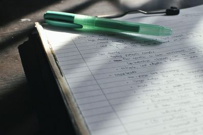 Close-up of hand writing on paper