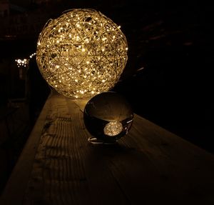 Close-up of illuminated lamp hanging on table