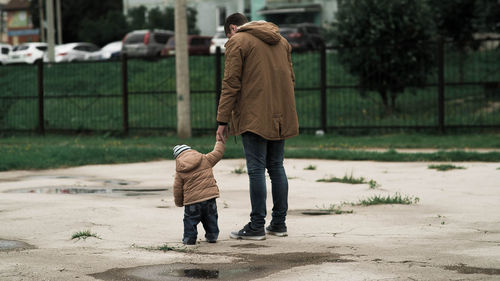 Rear view of men walking on street