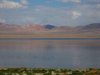 Scenic view of lake and mountains against sky