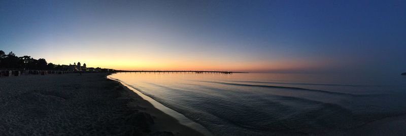 Scenic view of beach against sky during sunset