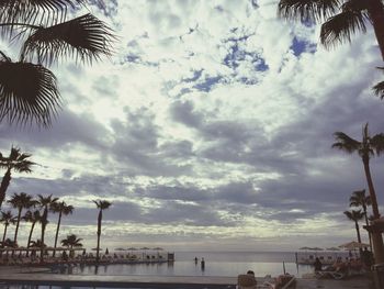 Scenic view of beach against cloudy sky