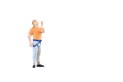 Full length of shirtless man standing against white background