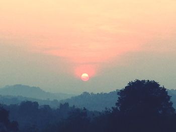 Scenic view of landscape against sky at sunset