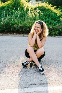 Portrait of smiling young woman sitting outdoors