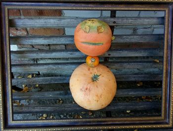 Close-up of orange pumpkins on wood