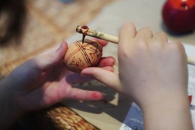 Cropped hands of woman holding christmas decoration