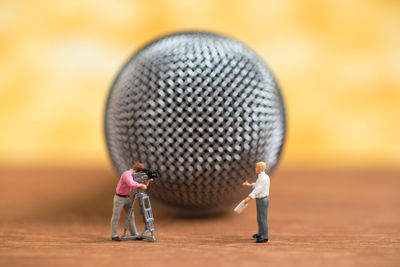 Close-up of figurines against microphone on table