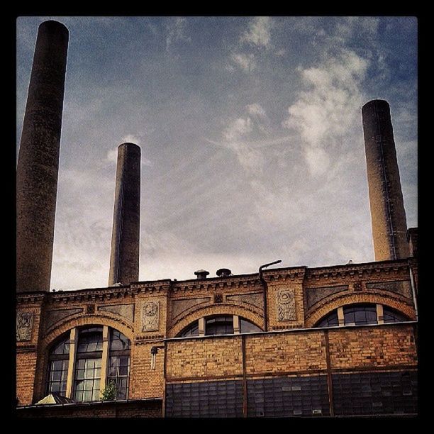 architecture, built structure, transfer print, building exterior, low angle view, sky, auto post production filter, cloud - sky, cloud, cloudy, tower, city, smoke stack, architectural column, travel destinations, factory, no people, history, outdoors, day