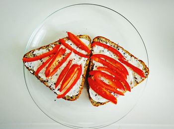 Close-up of red fruit over white background