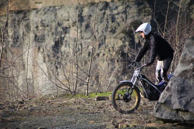 Woman on bicycle by tree