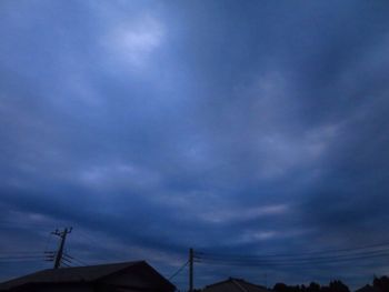 Low angle view of silhouette roof against sky