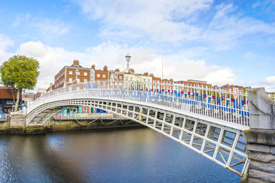 View of bridge over river against cloudy sky