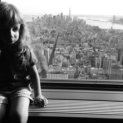 Full length of woman looking at city buildings