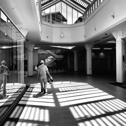 Rear view of man walking in building