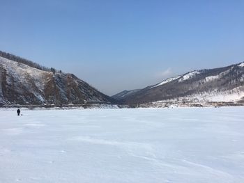 Scenic view of snowcapped mountains against clear blue sky