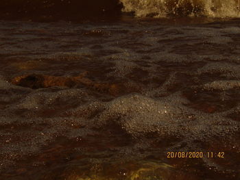 High angle view of text written on shore