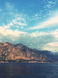 Scenic view of sea and mountains against sky