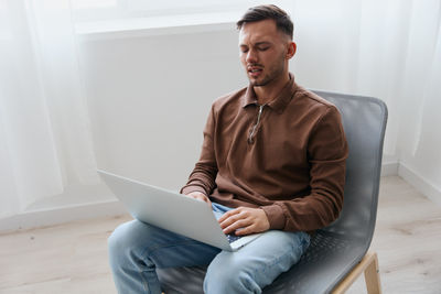 Young man using laptop at home