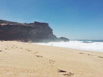 Scenic view of sea against blue sky