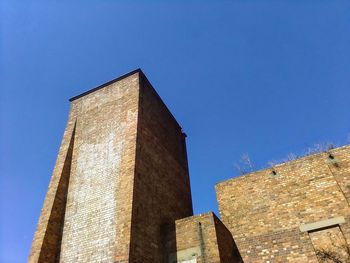 Low angle view of building against clear blue sky